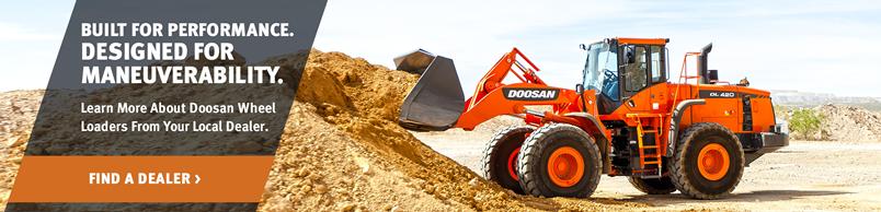Doosan DL420-5 Wheel Loader dumps a pile of dirt with a bucket attachment.